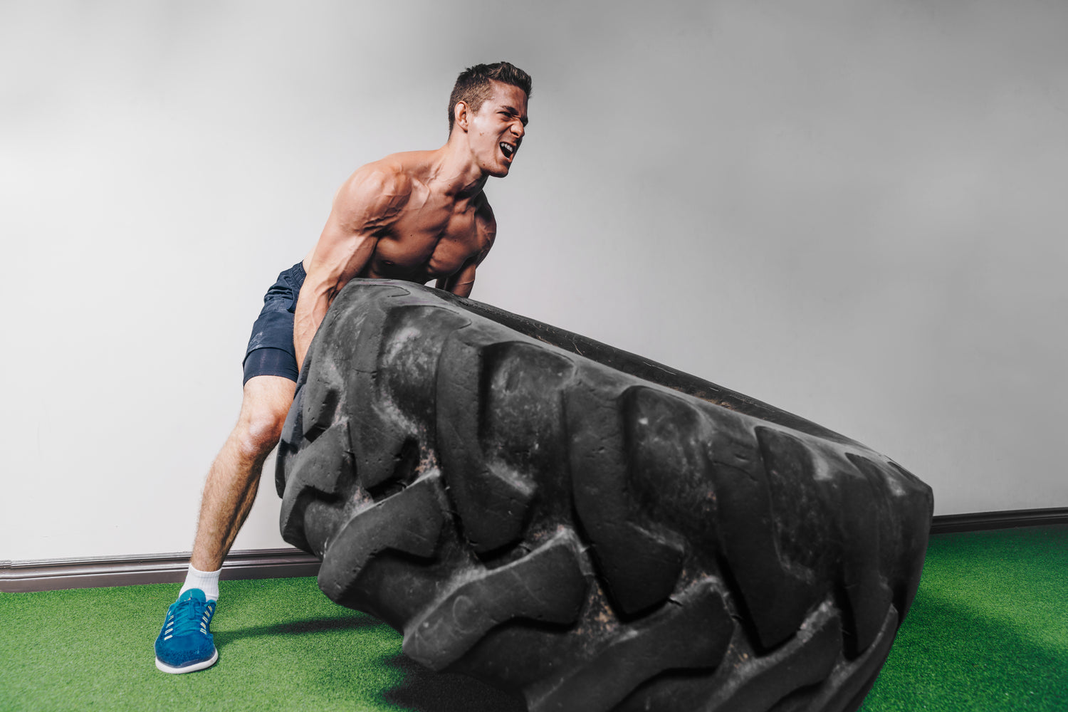 Athlete lifting heavy tire workout exercise